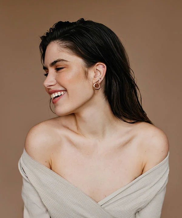 A smiling woman with healthy, radiant skin representing natural beauty and confidence.